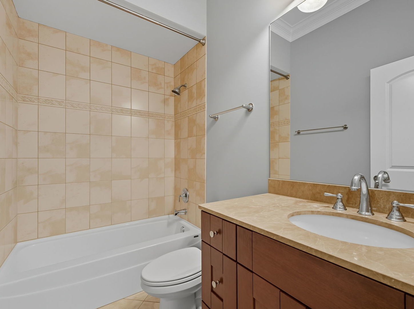1248 West Jackson Boulevard, Unit 4W Chicago, IL 60607 - Photo 21 of 24 a bathroom with a granite countertop bathtub shower sink mirror vanity and toilet
