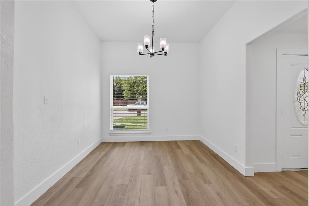 6021 Hartman Road Forest Hill, TX 76119 - Photo 2 of 27 wooden floor in an empty room with a window