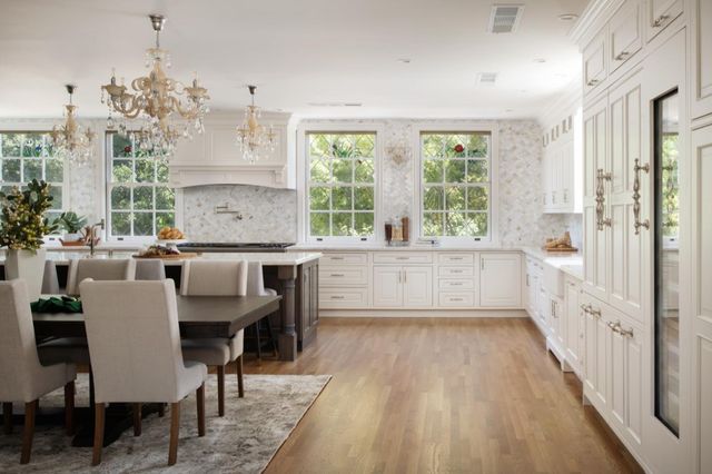 a large white kitchen with a large window