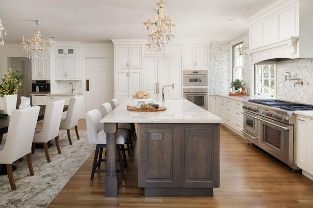 a kitchen with a table chairs stove and cabinets