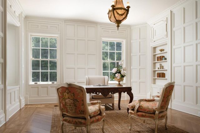 a view of a workspace with furniture and a window