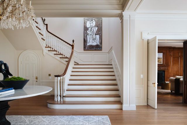 a view of entryway and hall with wooden floor