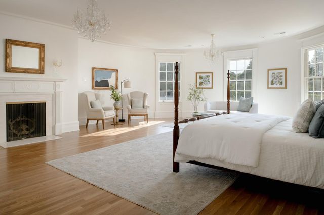 a spacious bedroom with a bed and a fireplace