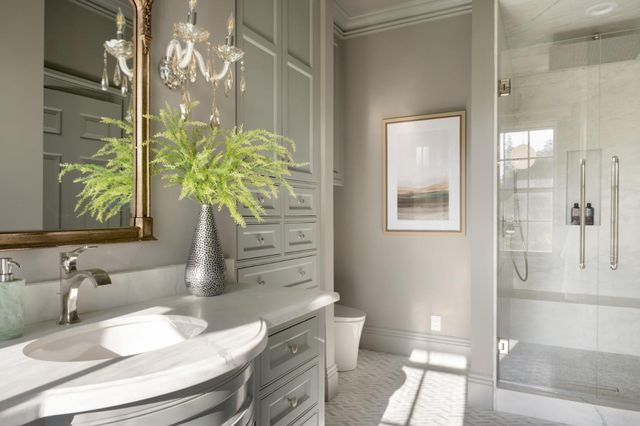 a bathroom with a granite countertop sink a toilet and shower