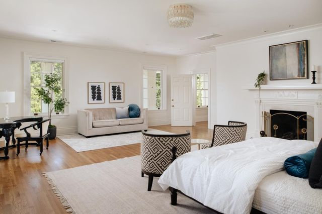 a spacious bedroom with two beds and a couch