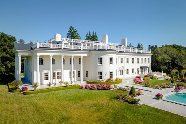 a view of a house with a yard patio and fire pit
