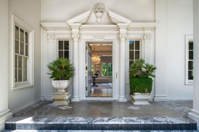 a view of a house with porch and glass windows