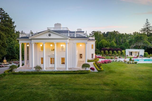 a front view of house with yard and outdoor seating