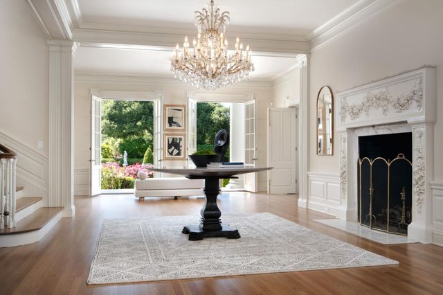 a living room with furniture and a chandelier