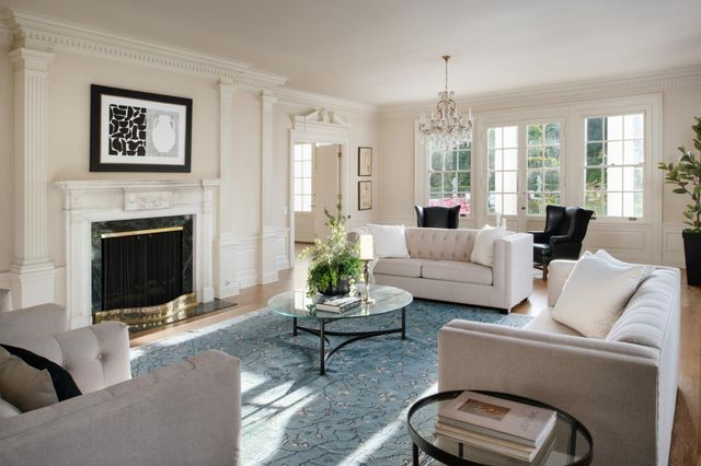 a living room with furniture fireplace and window
