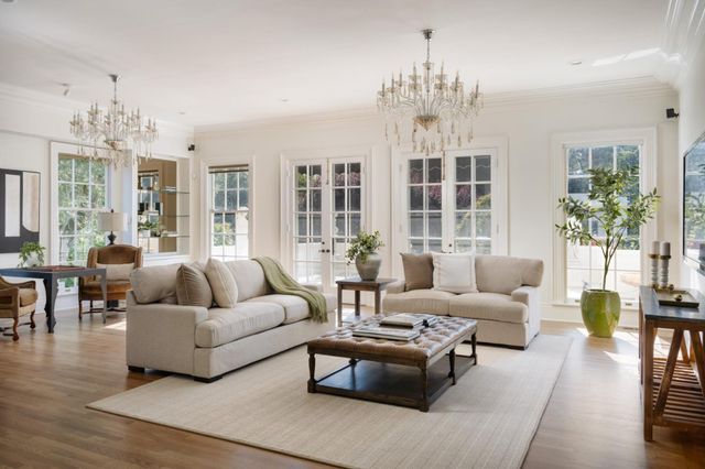 a living room with furniture and a chandelier