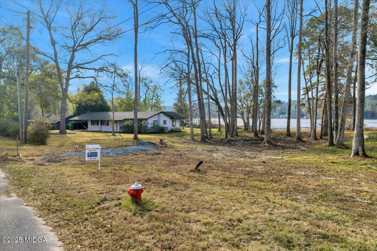 304 North Lake Drive Perry, GA 31069 - Photo 13 of 27 a green field with lots of trees in the background