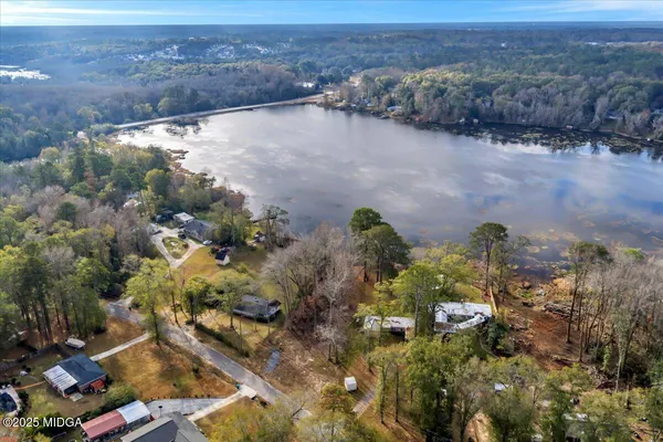 an aerial view of house with yard and mountain view in back