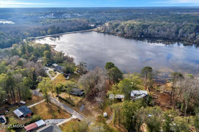 an aerial view of house with yard and mountain view in back