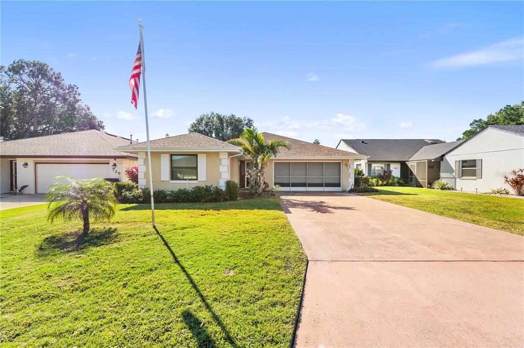 a house view with a swimming pool and a yard