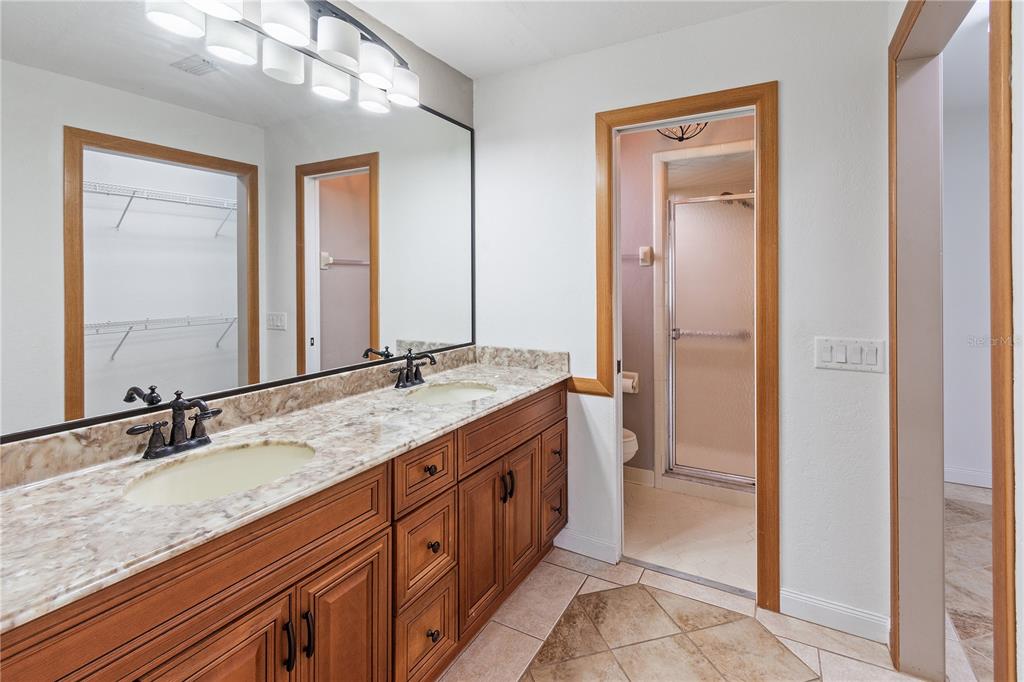 731 Canberra Road Winter Haven, FL 33884 - Photo 17 of 51 a bathroom with a granite countertop double vanity sink and a mirror