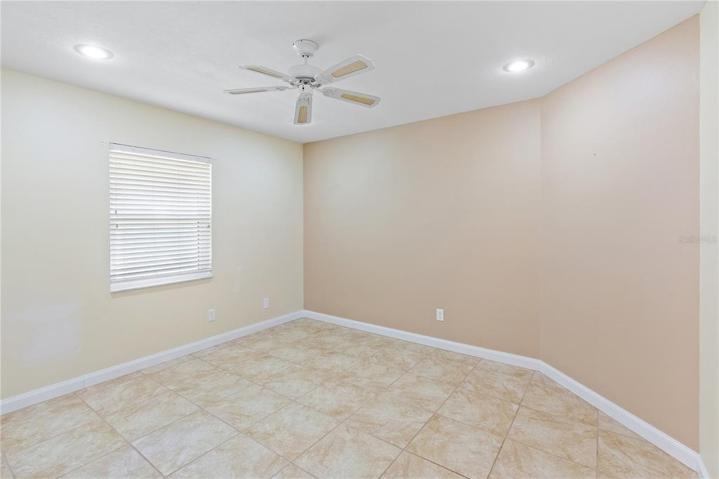 731 Canberra Road Winter Haven, FL 33884 - Photo 22 of 51 an empty room with a window and a fan