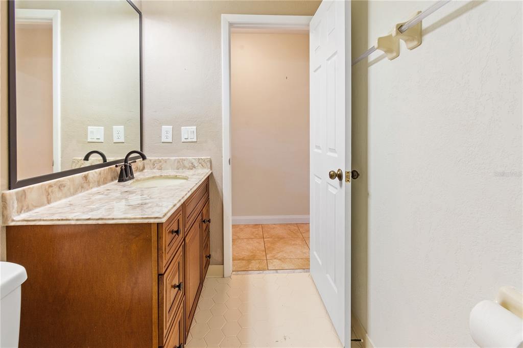 731 Canberra Road Winter Haven, FL 33884 - Photo 25 of 51 a bathroom with a granite countertop sink and a mirror