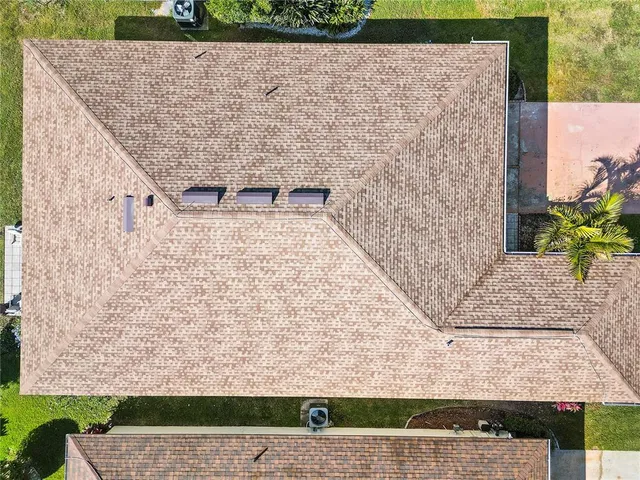 an aerial view of a house with a yard