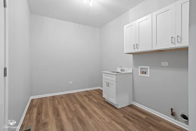 a view of a room with wooden floor and cabinet