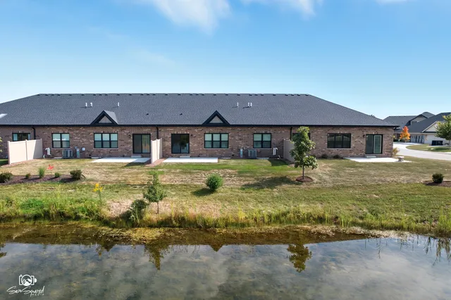an aerial view of residential building with outdoor space and ocean view