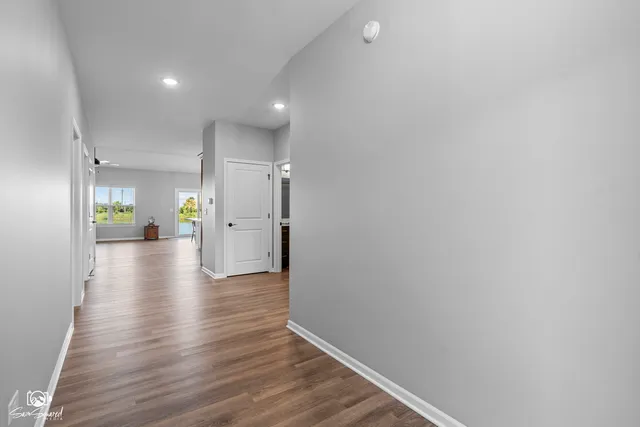 a view of an empty room and wooden floor