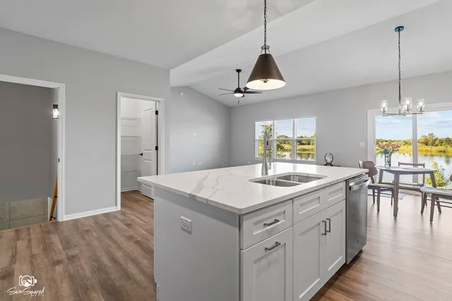 a kitchen with a counter space and wooden floor