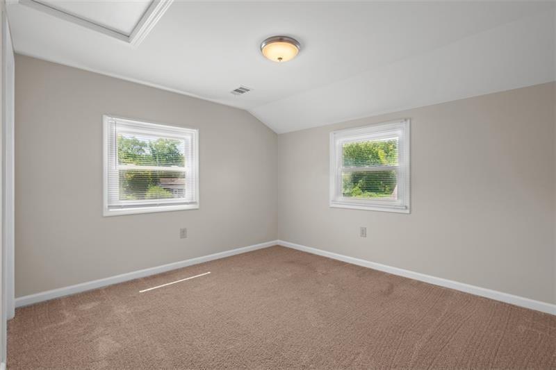 1122 Pittsburgh Road, Unit B Valencia, PA 16059 - Photo 10 of 12 an empty room with windows and mirror