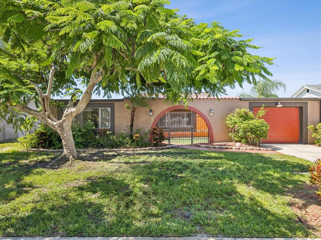 3730 Sail Drive New Port Richey, FL 34652 - Photo 1 of 50 a front view of a house with garden
