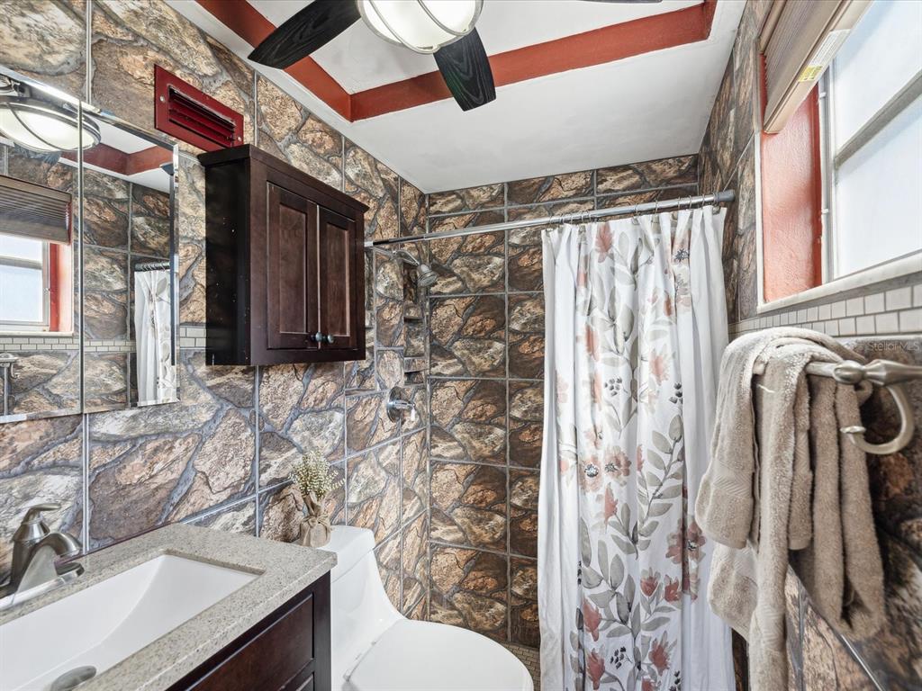 3730 Sail Drive New Port Richey, FL 34652 - Photo 19 of 50 a bathroom with a sink toilet and shower