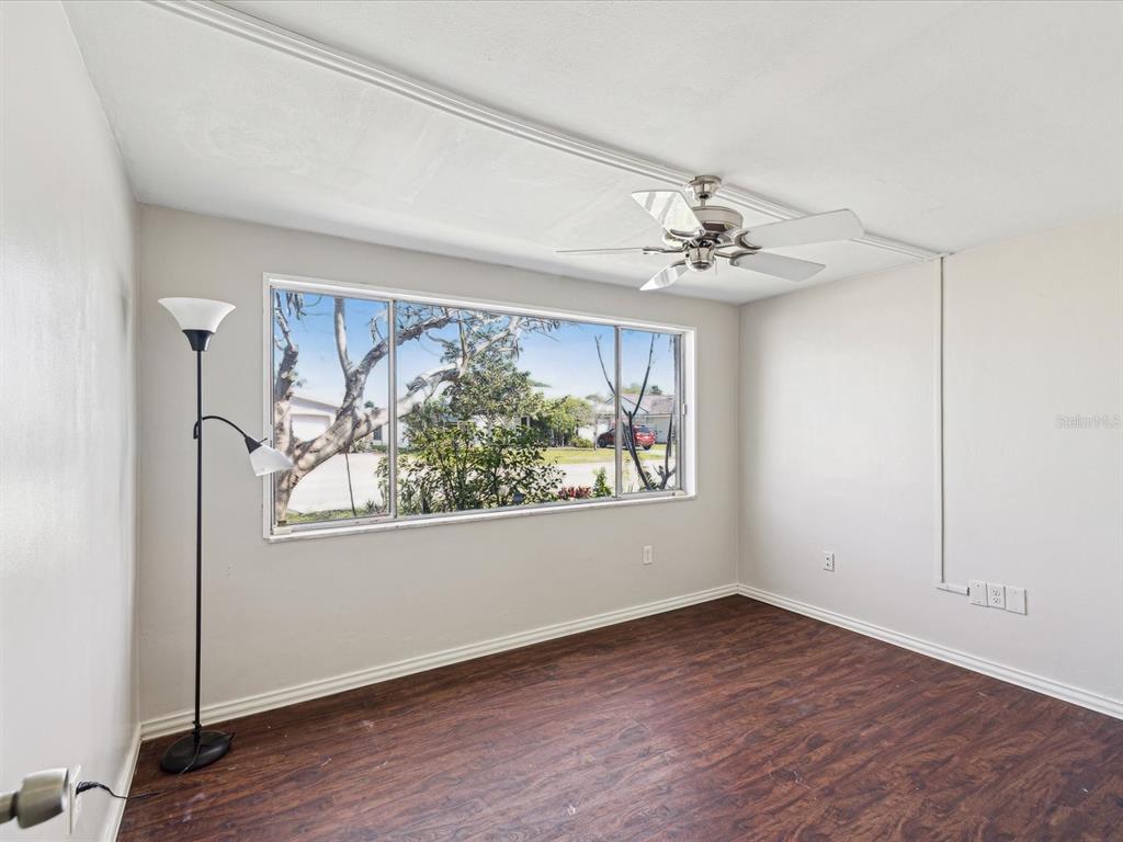 3730 Sail Drive New Port Richey, FL 34652 - Photo 21 of 50 wooden floor in an empty room with a window