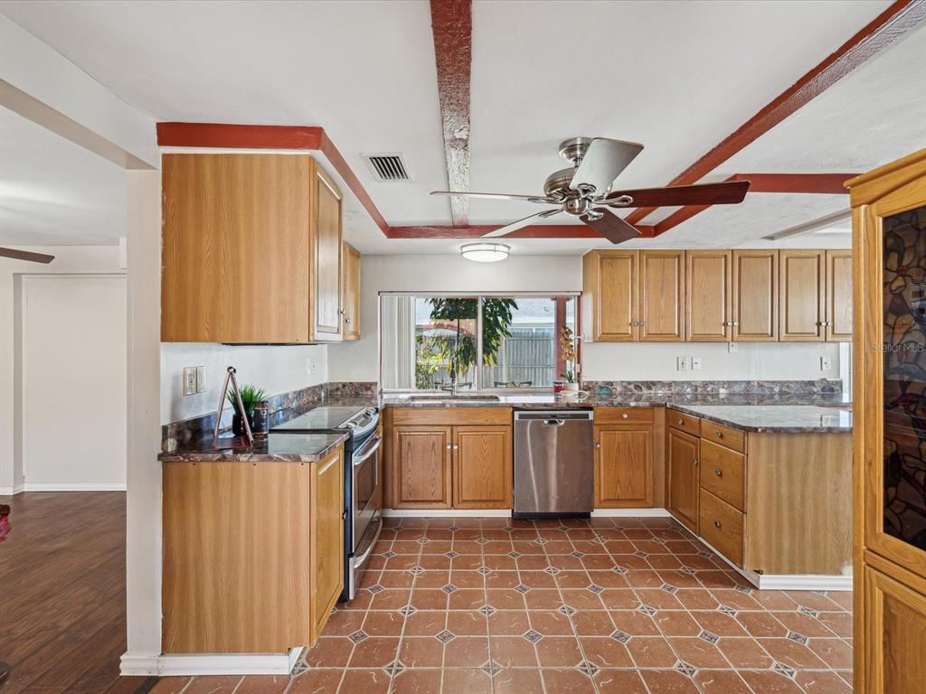 3730 Sail Drive New Port Richey, FL 34652 - Photo 7 of 50 a kitchen with stainless steel appliances granite countertop a sink and cabinets