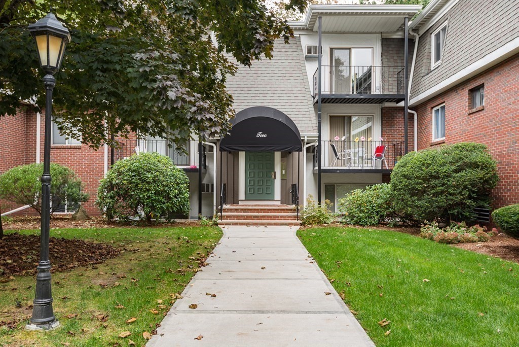 a front view of a house with a garden