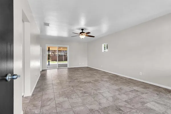 a view of an empty room with a ceiling fan
