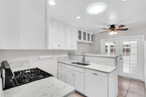 a kitchen with a sink stove and cabinets
