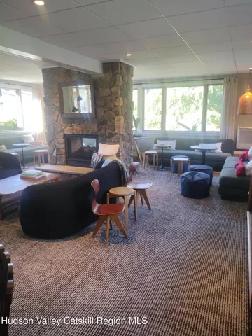 a living room with furniture a large window and a table