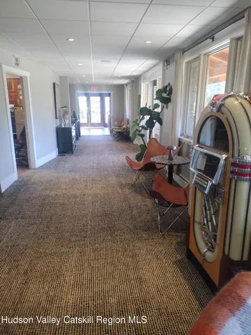 a living room with furniture a window and gym equipment