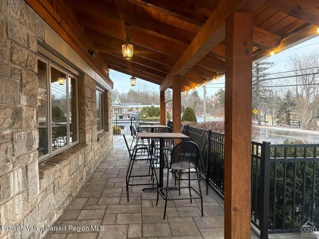 a view of a patio with table and chairs and wooden floor