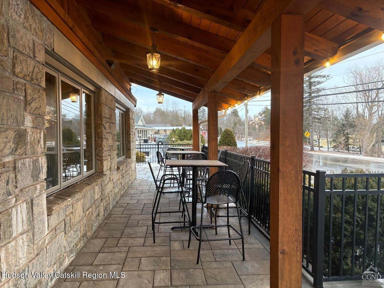 5220 Highway 23, Unit 126 Windham, NY 12496 - Photo 22 of 27 a view of a patio with table and chairs and wooden floor