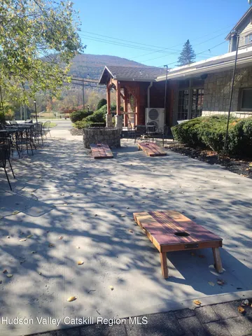 a view of a patio with table and chairs with wooden floor and plants
