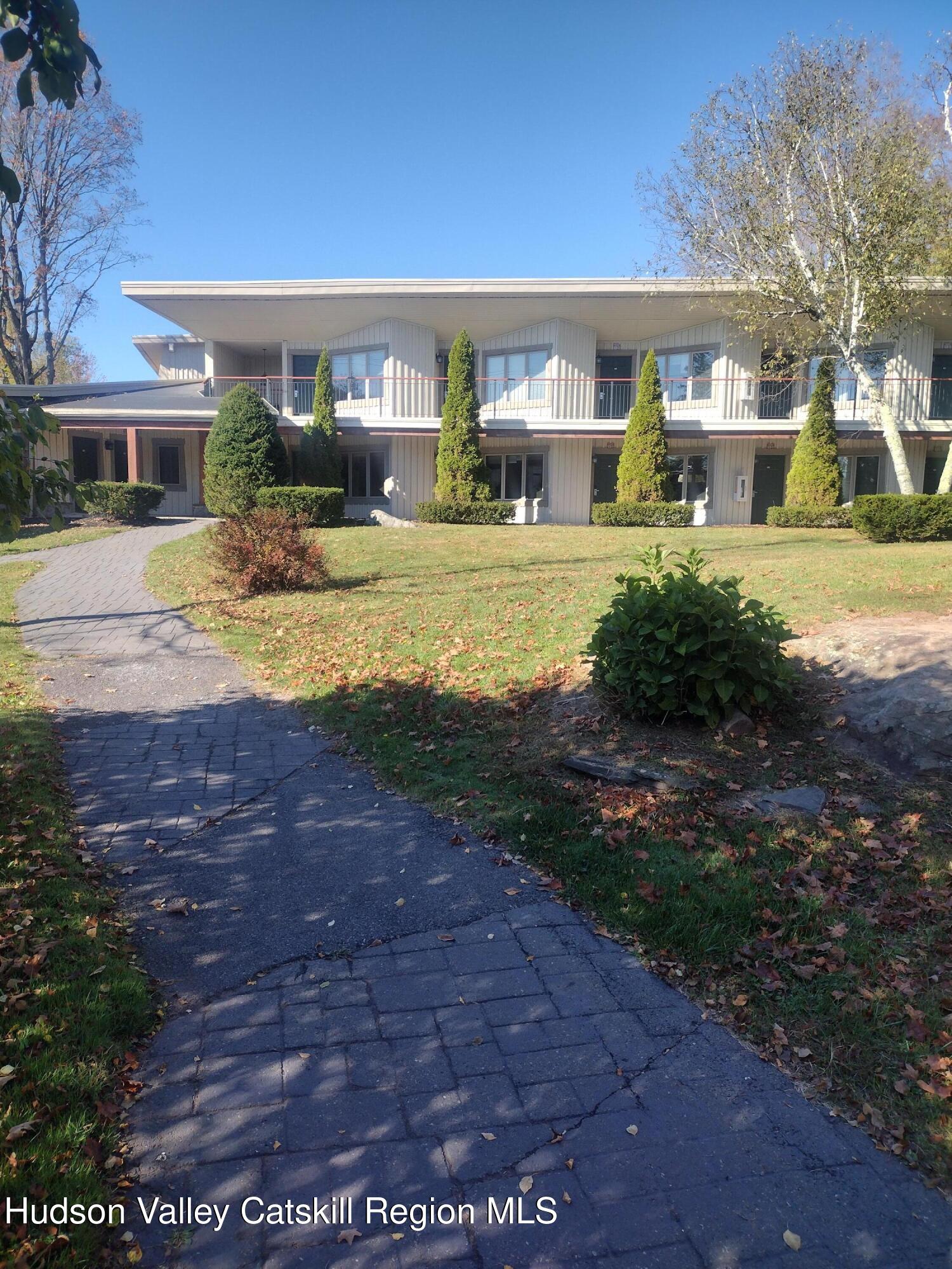 5220 Highway 23, Unit 126 Windham, NY 12496 - Photo 3 of 27 a front view of house with yard and green space