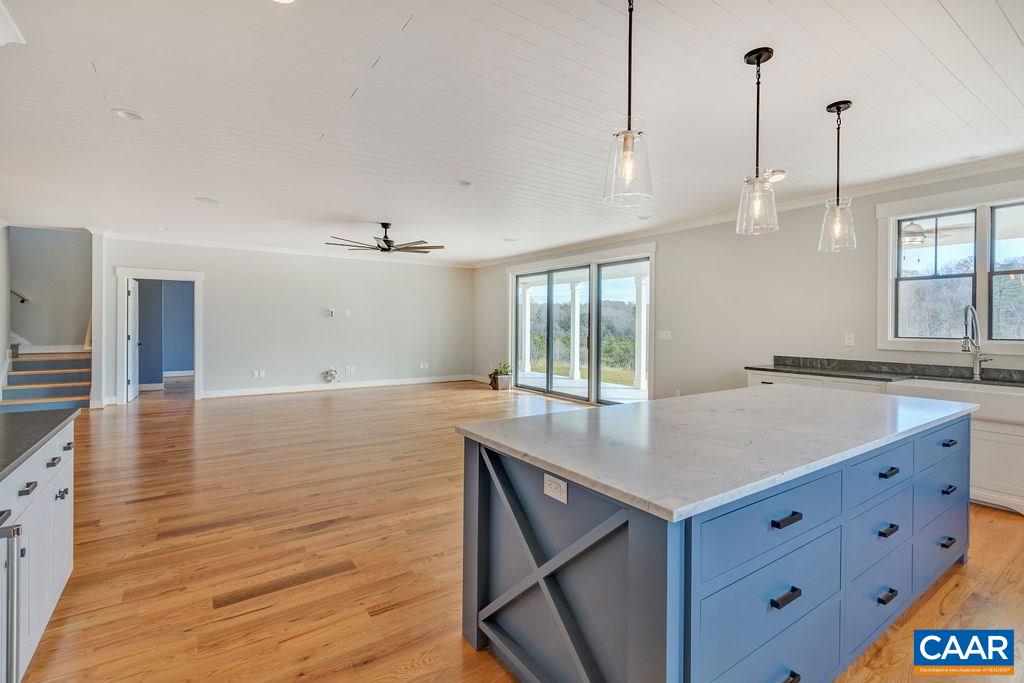 5797 Advance Mills Road Ruckersville, VA 22968 - Photo 12 of 50 a kitchen with a wooden floor and a large window