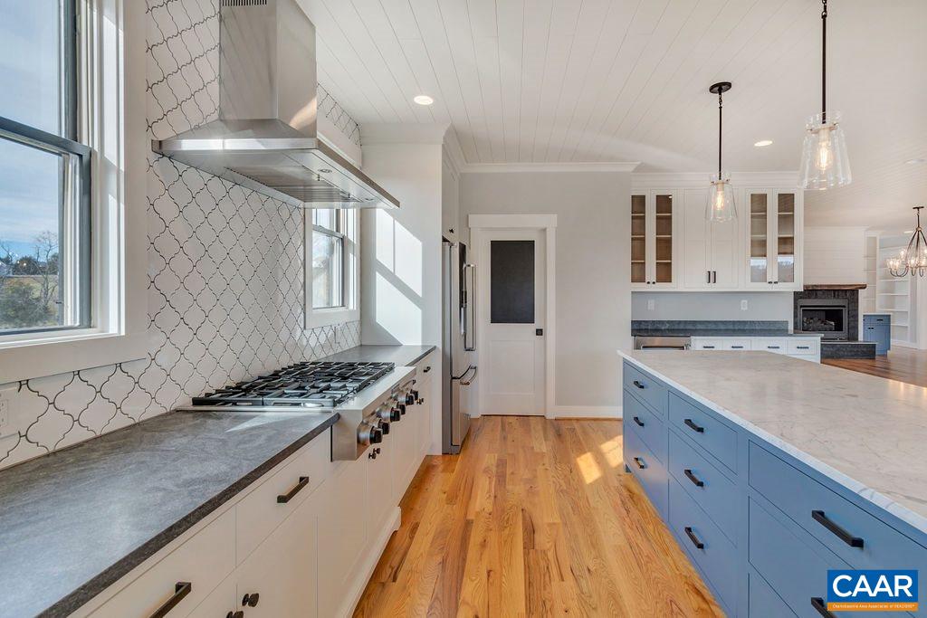 5797 Advance Mills Road Ruckersville, VA 22968 - Photo 13 of 50 a kitchen with stainless steel appliances granite countertop a lot of counter space and wooden floors