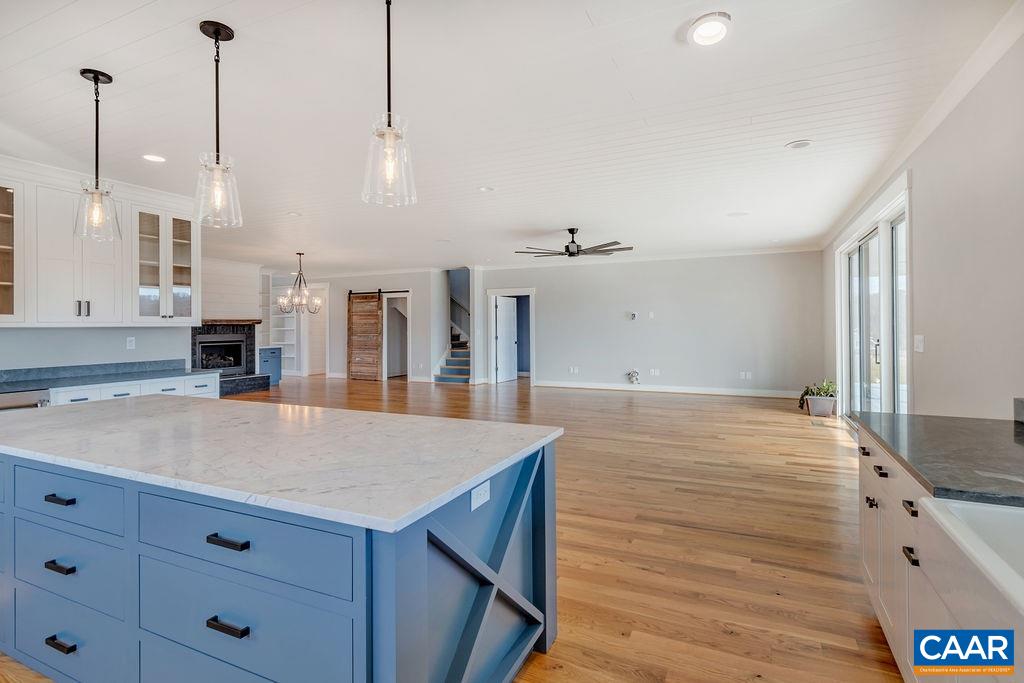5797 Advance Mills Road Ruckersville, VA 22968 - Photo 14 of 50 a room with kitchen island a sink dishwasher and wooden floor