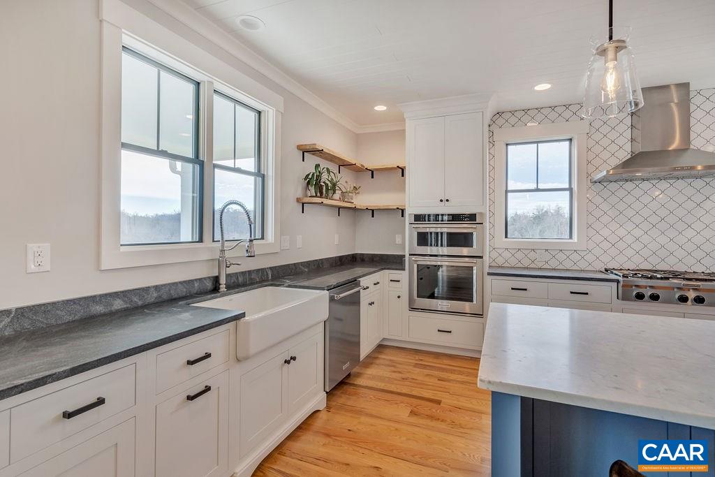 5797 Advance Mills Road Ruckersville, VA 22968 - Photo 16 of 50 a kitchen with stainless steel appliances granite countertop a sink stove and window