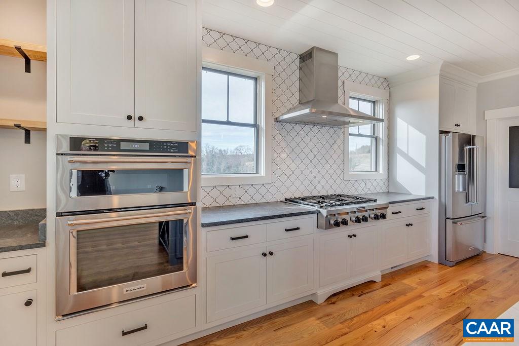 5797 Advance Mills Road Ruckersville, VA 22968 - Photo 17 of 50 a kitchen with granite countertop cabinets stainless steel appliances and a window