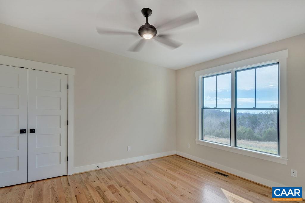 5797 Advance Mills Road Ruckersville, VA 22968 - Photo 22 of 50 wooden floor in an empty room with a window