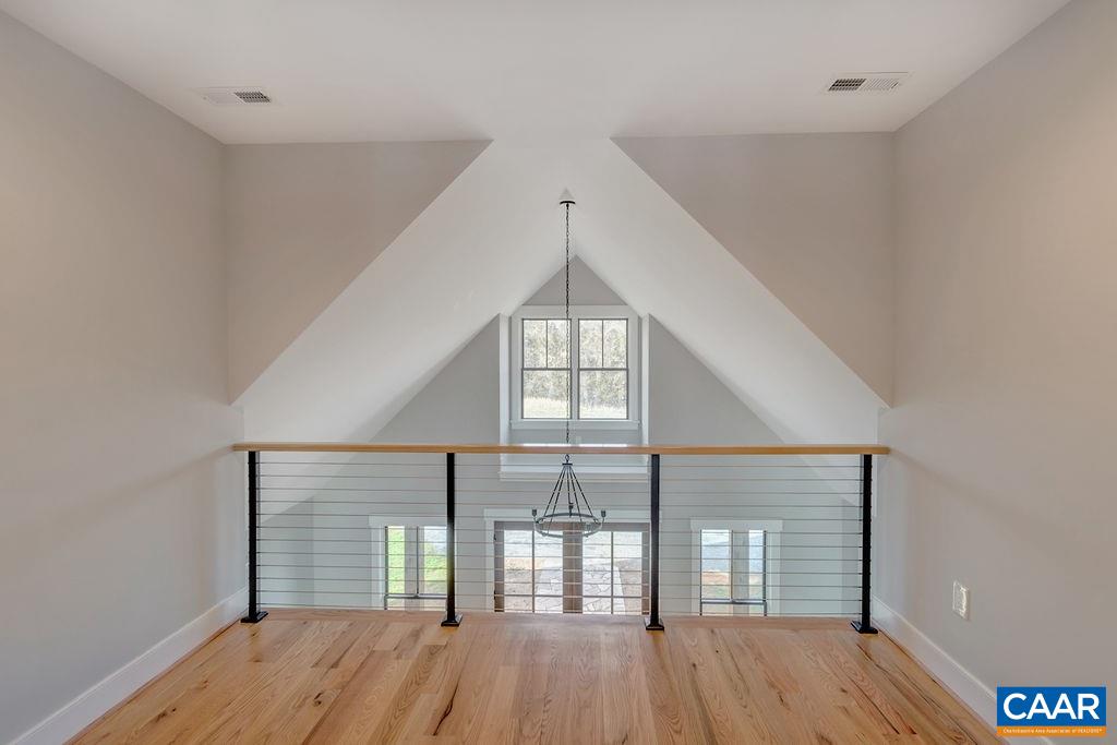 5797 Advance Mills Road Ruckersville, VA 22968 - Photo 26 of 50 a view of empty room with wooden floor and fan