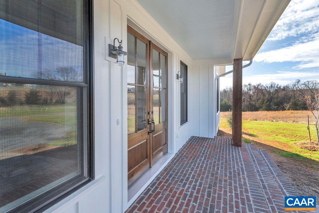 5797 Advance Mills Road Ruckersville, VA 22968 - Photo 3 of 50 a view of a room with wooden floor and a floor to ceiling window