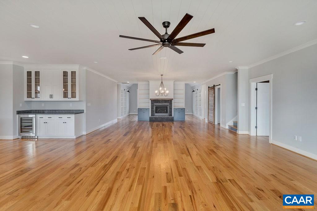 5797 Advance Mills Road Ruckersville, VA 22968 - Photo 7 of 50 a view of a livingroom with a fireplace a ceiling fan and wooden floor